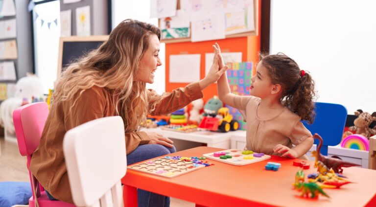 Teacher and Young Girl High-Five