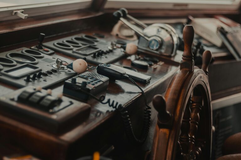 an old-fashioned wooden steering wheel of a ship