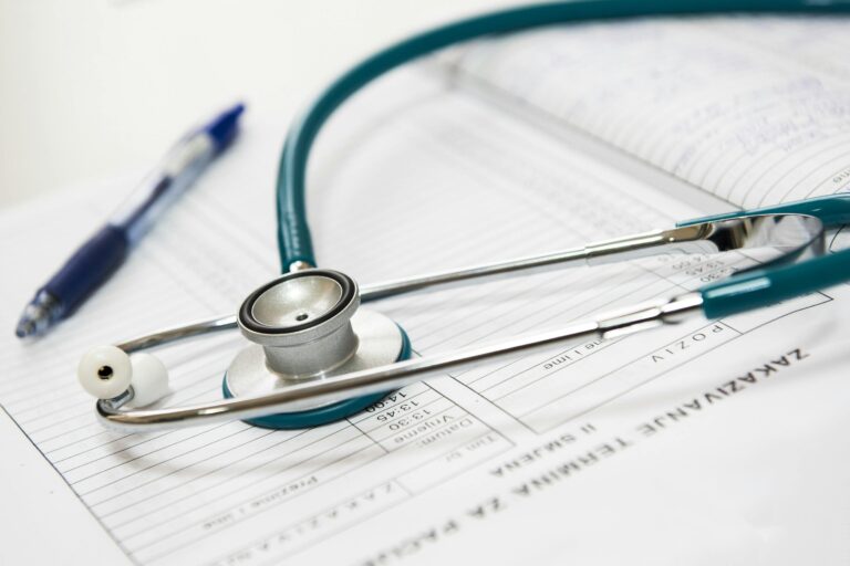 stethoscope and ballpoint pen lying on top of a medical chart