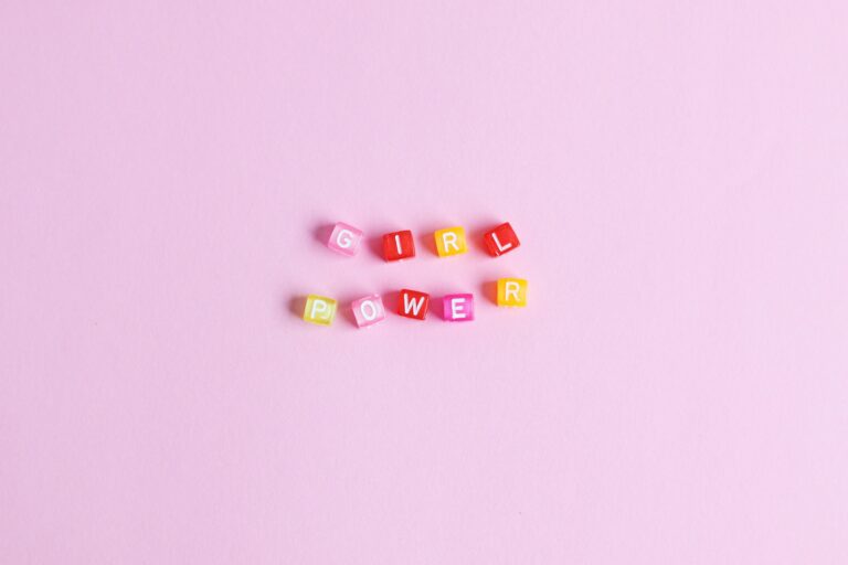 pink background with letter beads that spell out "girl power"