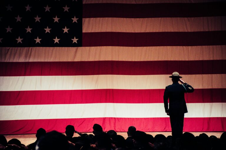 main in uniform saluting flag