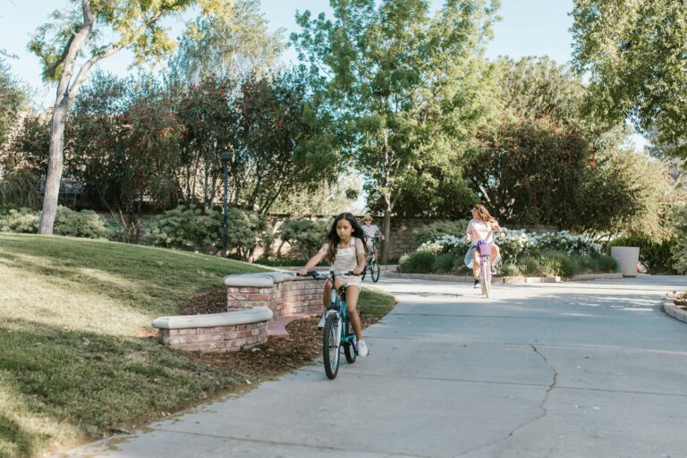 young girl on a bike riding down a suburban road